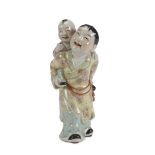 A CHINESE POLYCHROME PORCELAIN GROUP, 20TH CENTURY representing a Taoist divinity that supports a