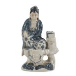 A CHINESE WHITE AND BLUE PORCELAIN SCULPTURE, 20TH CENTURY representing Guanyin that supports the