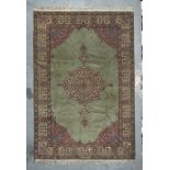 ARMENIAN CARPET, MID-20TH CENTURY with big flower medallion, in the center field on green ground.