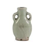 A SMALL CHINESE CERAMIC VASE. 19TH CENTURY decorated in celadon with small ribbon handles.