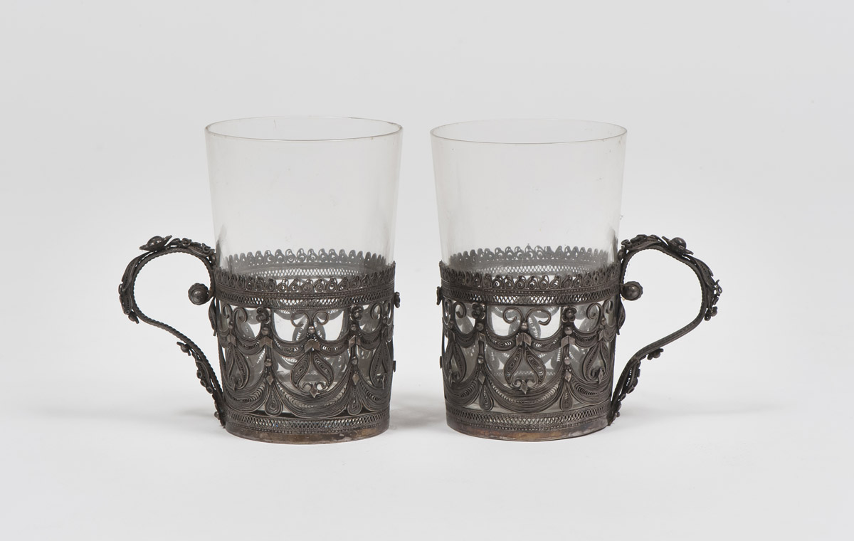 TWO GLASSHOLDERS IN SILVER AND FILIGREE, RUSSIA LATE 19TH CENTURY pierced to motifs of leaves and