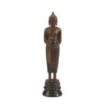 A CAMBODIAN RED AND BLACK LACQUERED WOOD SCULPTURE DEPICTING BUDDHA, 20TH CENTURY. representing