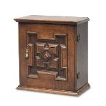 SMALL COIN CABINET IN OAK, PROBABLY PIEDMONT, END 18TH CENTURY sculpted with one door to cartouche