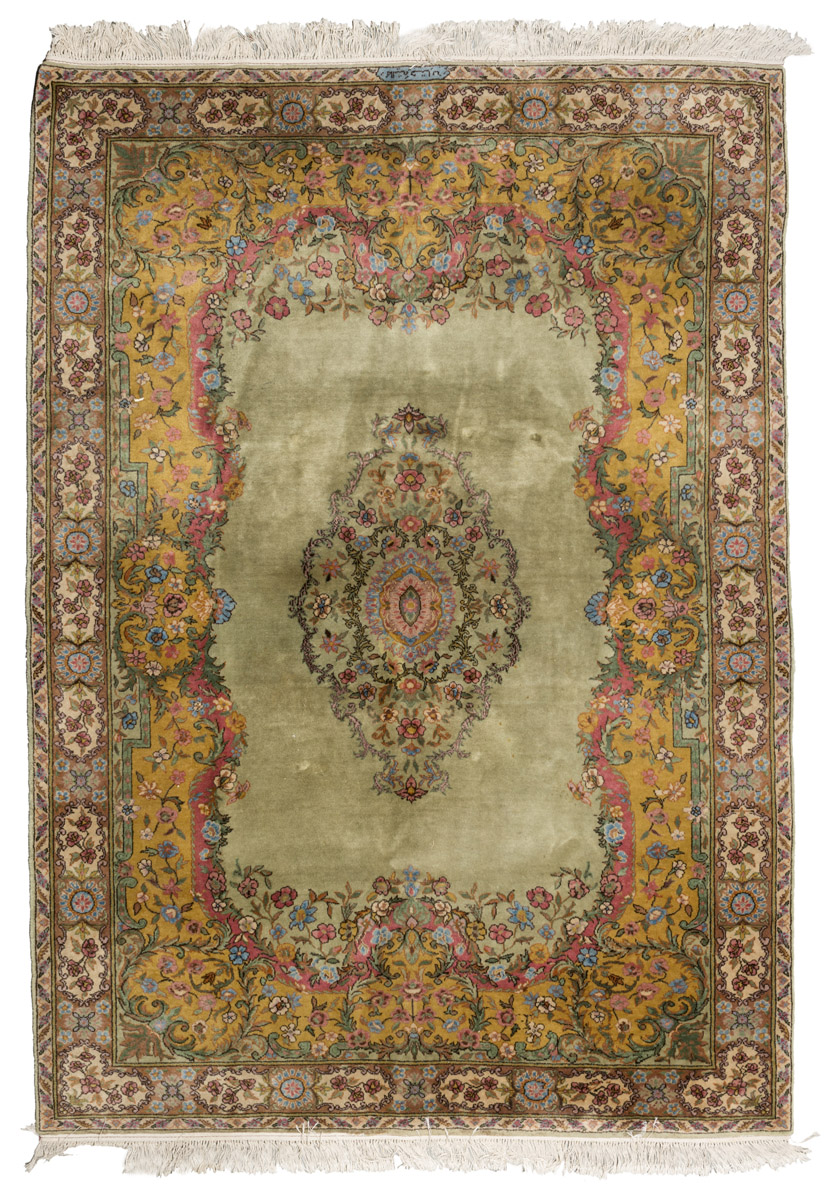 ANATOLIAN CARPET, EARLY 20TH CENTURY with floral medallion, in the center field on green ground.