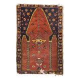 ANATOLIAN KONIA CARPET, LATE 19TH CENTURY Mirhab prayer design with lights and rosettes, in the