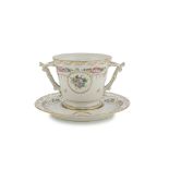 PORCELAIN CUP AND SAUCER, LIMOGES 20TH CENTURY decorated with flowers and gold. Bush handles.