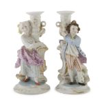 A Pair of Porcelain Candlesticks, Early 20TH CENTURY in polychromy, representing young girl.