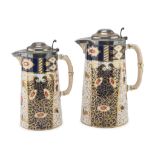 TWO CERAMIC JUGS, ENGLAND, LATE 19TH CENTURY with polychrome floral decorums and silver covers.