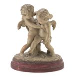 GROUP WITH CHERUBS IN EARTHENWARE, 19TH CENTURY in playful pose, oval plainbase. Red lacquered foot.