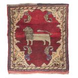 SMALL KURDISH CARPET, EARLY 20TH CENTURY with central figure of lion in the field on red ground.