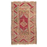 ANATOLIAN KARAKECILI CARPET, EARLY 20TH CENTURY with rhomboidal medallion on red ground. Measures