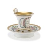 PORCELAIN CUP AND SAUCER, GERMANY 19TH CENTURY decorated with garlands in polychromy and gold.