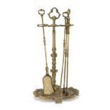 BRONZE FIREPLACE SET, EARLY 20TH CENTURY three utensils and stand decorated with floral motifs.