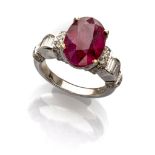 BEAUTIFUL RING in white gold 18 kts. with central oval cut ruby and various round cut and baguette-