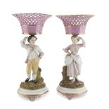 A PAIR OF BASKETS IN PORCELAIN, FRANCE 19TH CENTURY in pink and polychrome enamel, shafts as figures