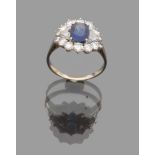 SPLENDID RING in white gold 18 kts., flower-shaped with central sapphire and diamond contour.