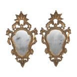 A PAIR OF SMALL MIRRORS IN GILTWOOD, LATE 19TH CENTURY of eighteenth-century taste, carved into