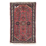 SMALL ANATOLIAN CARPET, EARLY 20TH CENTURY with design of flower branches on red ground. Measures