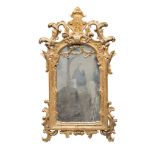GILTWOOD MIRROR, ELEMENTS OF THE 18TH CENTURY entirely sculpted to motifs for spiral scrolls,