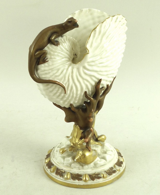 A Royal Worcester nautilus shell with applied salamander, the stem formed as coral and seaweed,