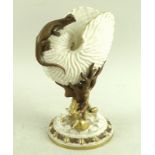 A Royal Worcester nautilus shell with applied salamander, the stem formed as coral and seaweed,