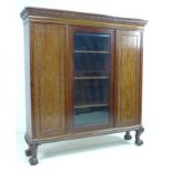 A good Edwardian mahogany bookcase, outswept cornice with foliate carved decoration,