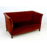 An Edwardian two seater settee, with gently outswept sides,