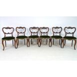 A set of six Victorian rosewood dining chairs, with carved rails and moulded frames,