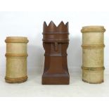 A group of three chimney pots, one with crown top and dark brown glaze, 35 by 74cm high,