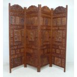A pair of modern decorative carved and stained wood three fold room screens,