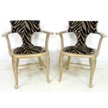 A pair of modern open armchairs, gilded wooden frames with faux zebra skin upholstery,