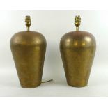 A pair of beaten copper table lamps, late 20th century, of tapering ovoid form,