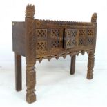 A modern carved and stained wood cupboard, in Middle Eastern style,