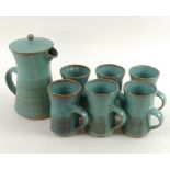 A studio pottery coffee set, comprising a lidded coffee pot, 14 by 19cm, with six mugs, 9.5 by 11.