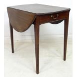 A Regency mahogany Pembroke table, the oval surface with drop leaves,