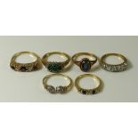 A group of six 9ct gold rings, comprising a ring set with three emeralds surrounded by diamonds,