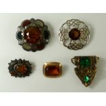 A group of five brooches, comprising a 19th century Scottish cairngorm brooch,