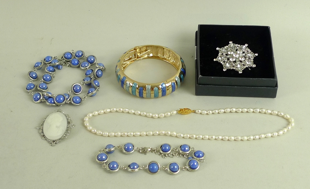 A large quantity of vintage and later costume jewellery, including a locket, a jade cross,