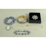 A large quantity of vintage and later costume jewellery, including a locket, a jade cross,