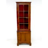 A 19th century walnut veneered narrow bookcase, single glazed door with eight panes,