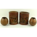 A pair of Qing Dynasty Chinese bamboo brush pots, each carved in relief with water buffalo,