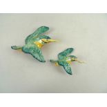 A Beswick wall plaque, modelled as a kingfisher, impressed number 729-1, flying right, green/yellow,