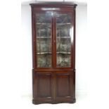 A George III mahogany and line inlaid corner cupboard,