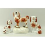 A Staffordshire ceramic figure of a King Charles spaniel, standing with bocage at feet, 13cm,