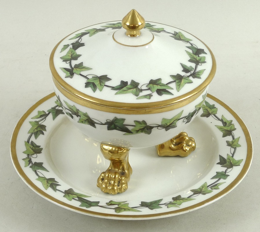 A KPM Berlin porcelain tureen, cover and stand, both painted with bands of trailing ivy, gilt rims,