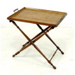 An early 20th century butler's tray and stand, the oak tray with twin turned handles,