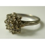 An 18ct white gold and diamond cluster ring, the central stone of approximately 0.