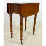 A Regency mahogany Pembroke table, two drawers with brass knobs opposite two false drawers,