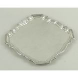 A large silver salver, the square body with stepped and shaped rim, Birmingham 1934,