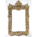 A 19th century giltwood rococo carved frame, the crest applied with rosettes,